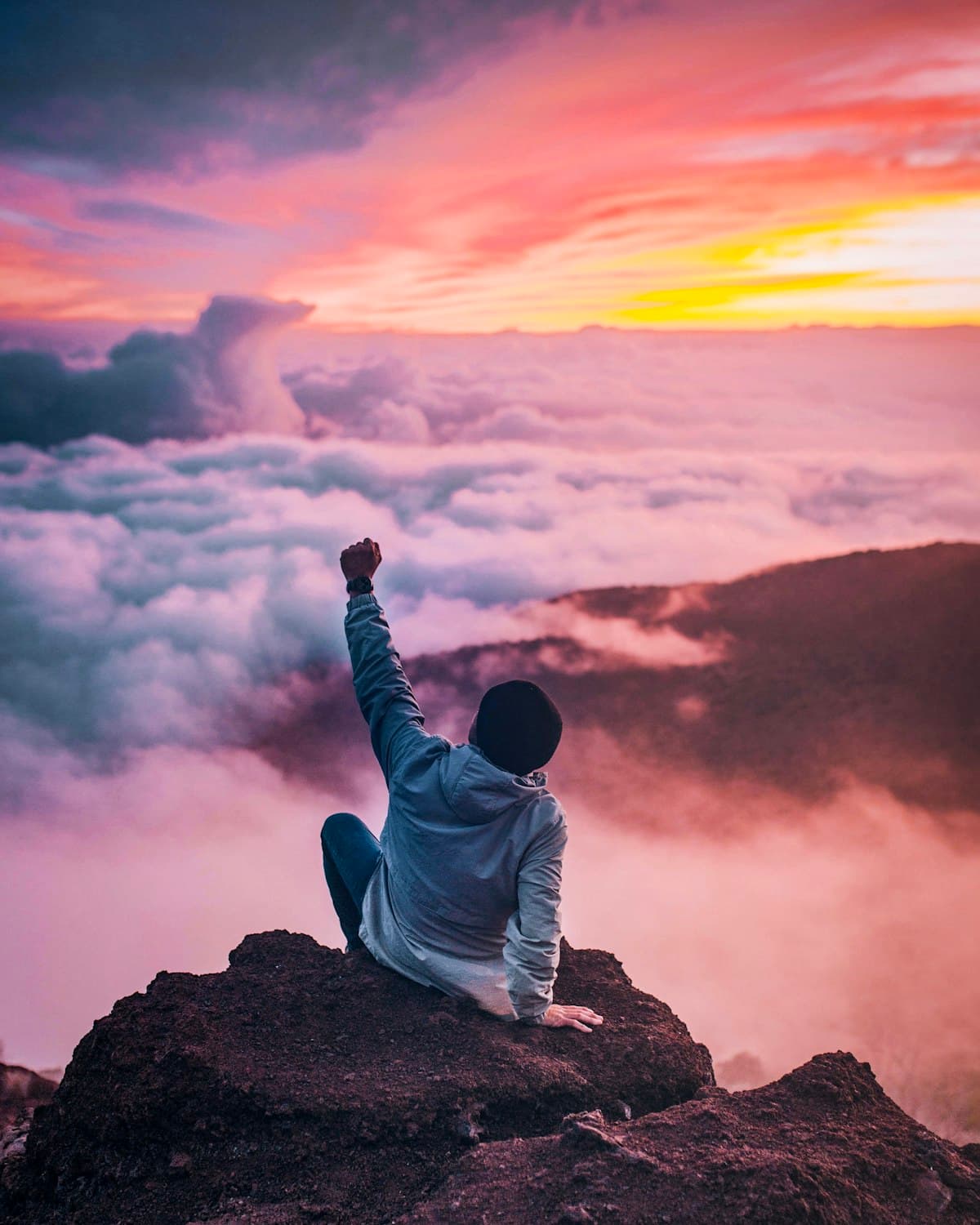 Person celebrating on a mountain summit